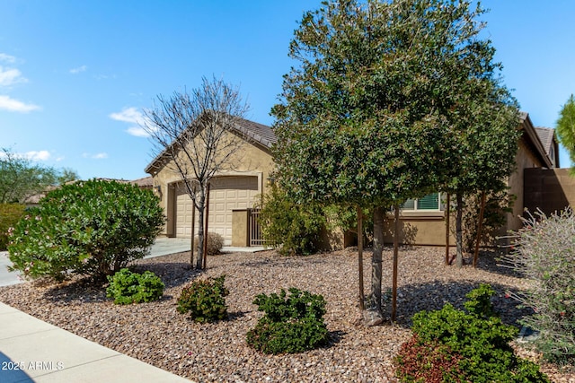 obstructed view of property with concrete driveway, a garage, and stucco siding