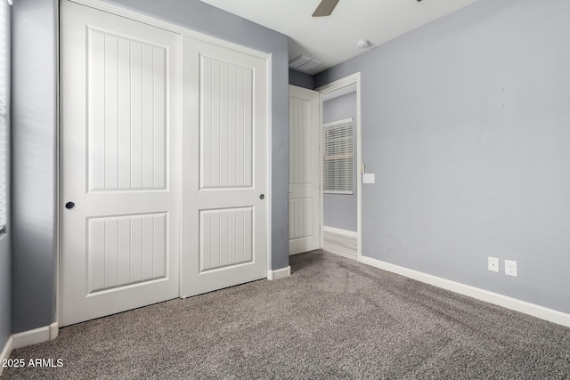 unfurnished bedroom featuring a closet, visible vents, baseboards, and carpet