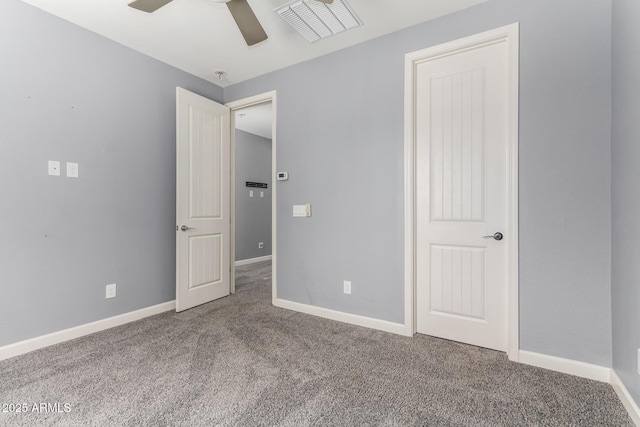 unfurnished bedroom featuring baseboards, carpet floors, visible vents, and ceiling fan