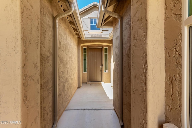 doorway to property featuring stucco siding