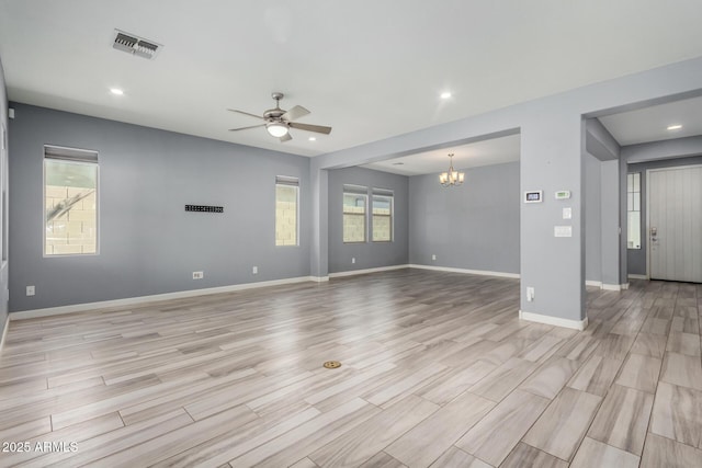 unfurnished living room featuring visible vents, baseboards, recessed lighting, ceiling fan with notable chandelier, and light wood-style floors