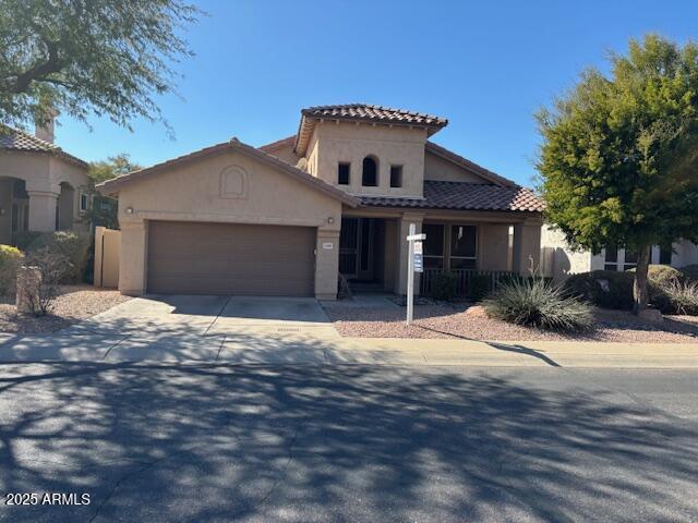 mediterranean / spanish-style home featuring a garage