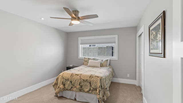 carpeted bedroom with baseboards and ceiling fan