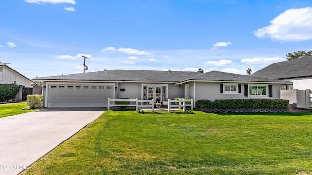 ranch-style house featuring fence, concrete driveway, a front yard, french doors, and a garage