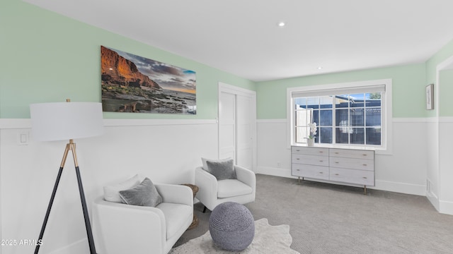 living area with wainscoting and carpet floors