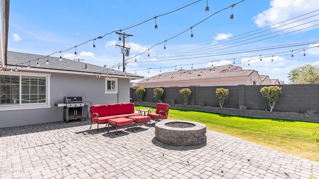 view of patio featuring grilling area, an outdoor living space with a fire pit, and a fenced backyard