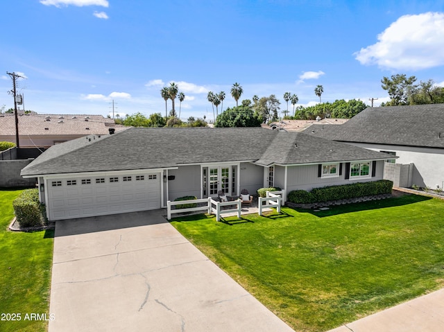 single story home with a garage, concrete driveway, a front lawn, and a shingled roof