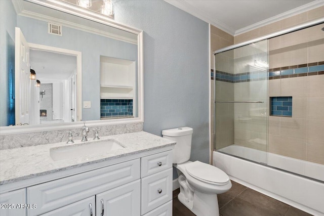 full bath with vanity, toilet, combined bath / shower with glass door, visible vents, and ornamental molding