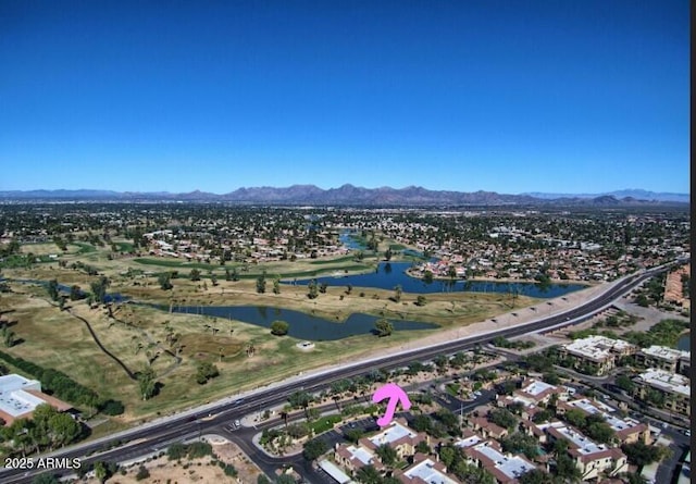 drone / aerial view featuring a water and mountain view and a residential view