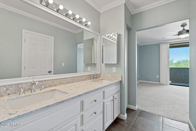 bathroom featuring baseboards, tile patterned flooring, double vanity, and a sink