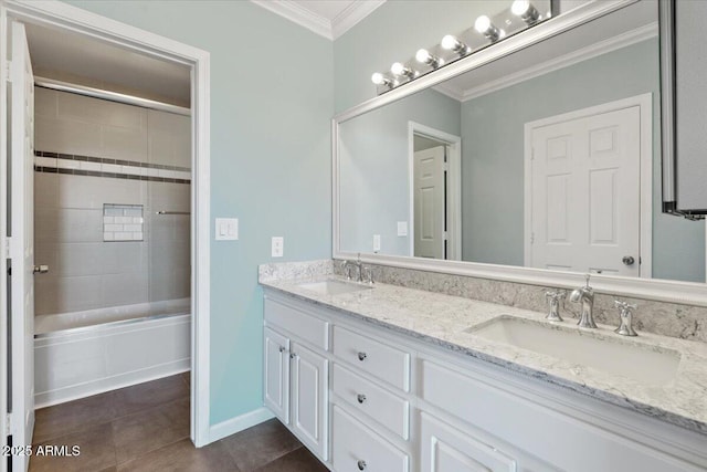 full bath featuring double vanity, ornamental molding, tile patterned flooring, and a sink