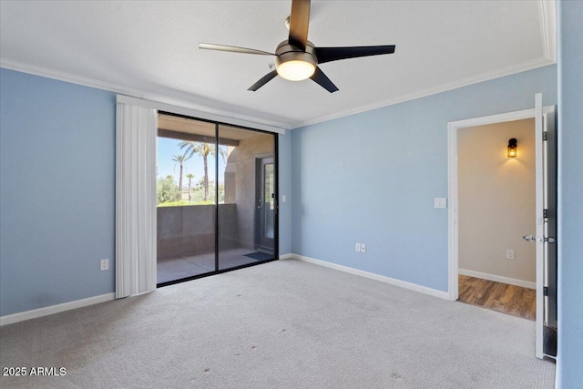 unfurnished room with baseboards, ornamental molding, a ceiling fan, and carpet flooring
