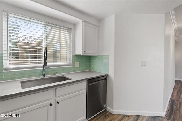 kitchen with white cabinets, baseboards, dishwasher, dark wood finished floors, and backsplash