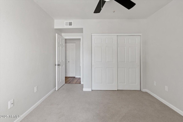unfurnished bedroom with visible vents, ceiling fan, a closet, baseboards, and carpet