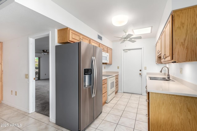 kitchen featuring ceiling fan, sink, light tile patterned floors, and white appliances