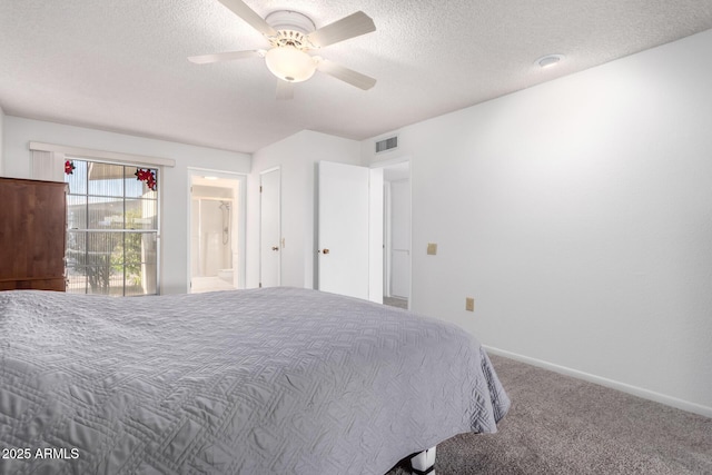 carpeted bedroom featuring ceiling fan, ensuite bath, and a textured ceiling