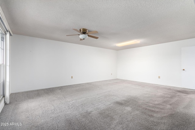 carpeted spare room with ceiling fan and a textured ceiling