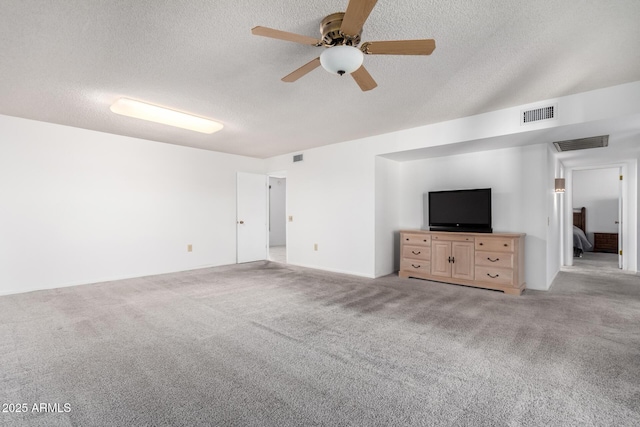 unfurnished living room with ceiling fan, light carpet, and a textured ceiling