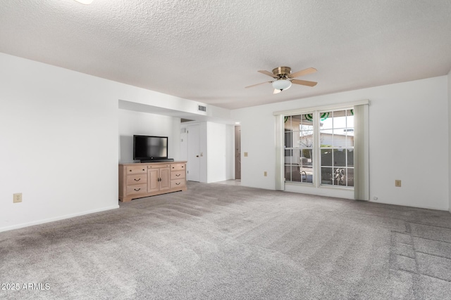 unfurnished living room featuring a textured ceiling, carpet floors, and ceiling fan