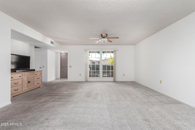 unfurnished living room with ceiling fan, light colored carpet, and a textured ceiling