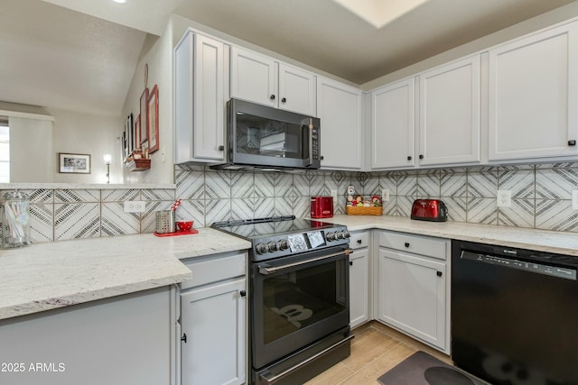 kitchen featuring electric stove, white cabinets, tasteful backsplash, and black dishwasher