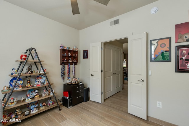 rec room featuring ceiling fan and light wood-type flooring