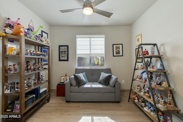 living area featuring light hardwood / wood-style flooring and ceiling fan