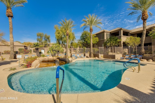 view of swimming pool featuring a water slide and a patio