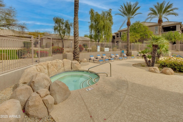 view of swimming pool featuring a patio area and a hot tub