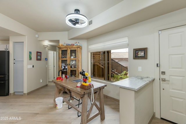 dining space featuring light wood-type flooring