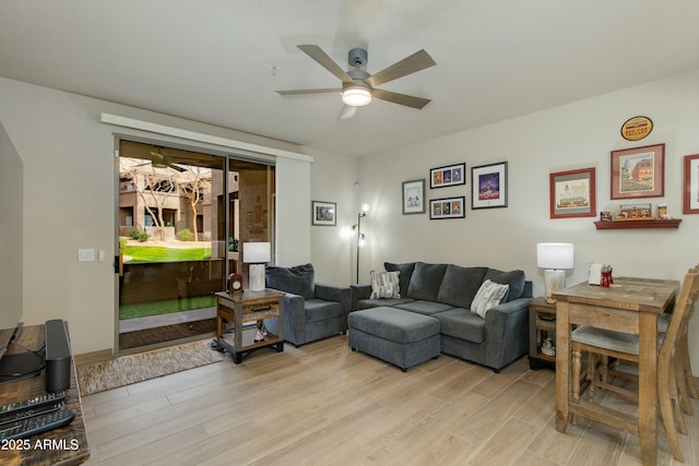 living room with ceiling fan and light wood-type flooring