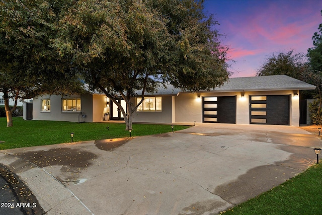 view of front facade with a lawn and a garage