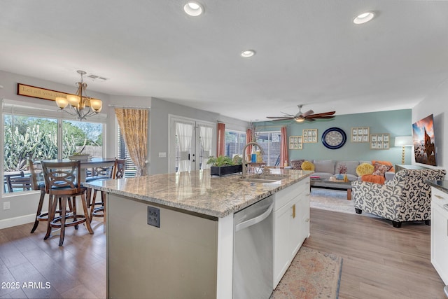 1264 S Sierra St, Gilbert, AZ 85296 - kitchen with stainless steel dishwasher, a sink, light wood-style flooring, white cabinetry, and a chandelier