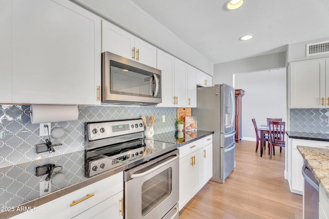 1264 S Sierra St, Gilbert, AZ 85296 - kitchen with stainless steel appliances, white cabinetry, decorative backsplash, light wood-style flooring, and recessed lighting