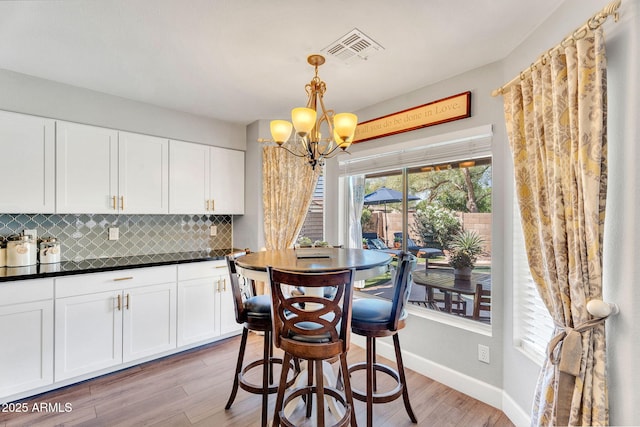 1264 S Sierra St, Gilbert, AZ 85296 - dining room featuring a chandelier, light wood-type flooring, and baseboards