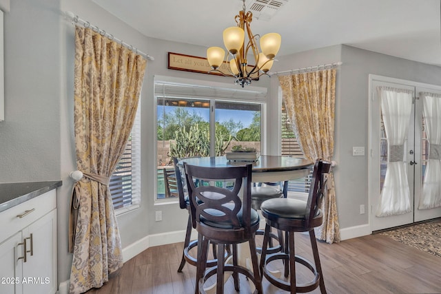 1264 S Sierra St, Gilbert, AZ 85296 - dining area featuring wood finished floors, plenty of natural light, baseboards, and a chandelier