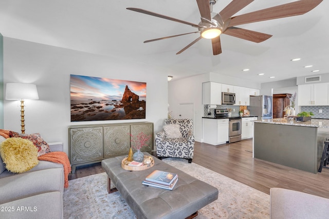 1264 S Sierra St, Gilbert, AZ 85296 - living area featuring dark wood finished floors, ceiling fan, and recessed lighting
