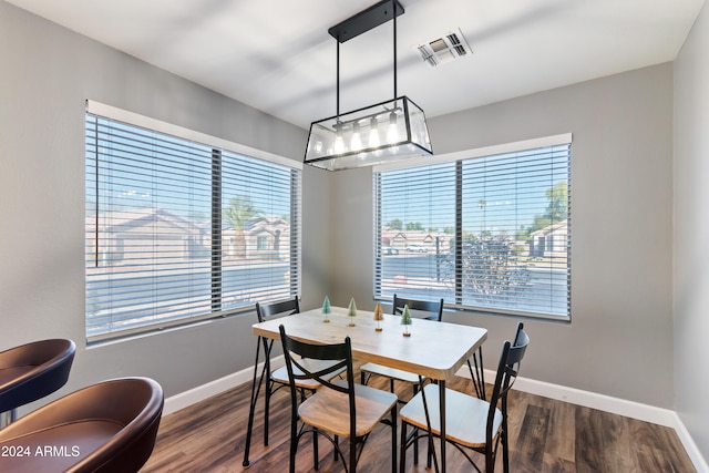 dining space with dark hardwood / wood-style flooring