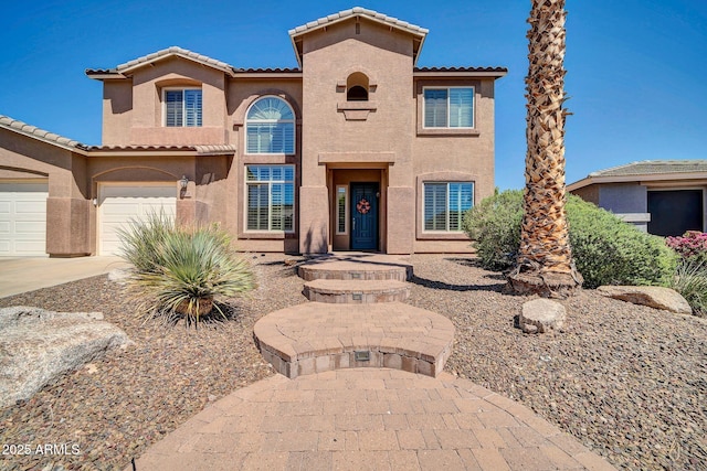 mediterranean / spanish-style home with a garage