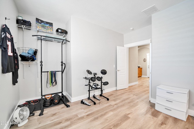 exercise area with light wood-type flooring