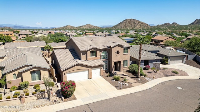 view of front of property with a mountain view and a garage