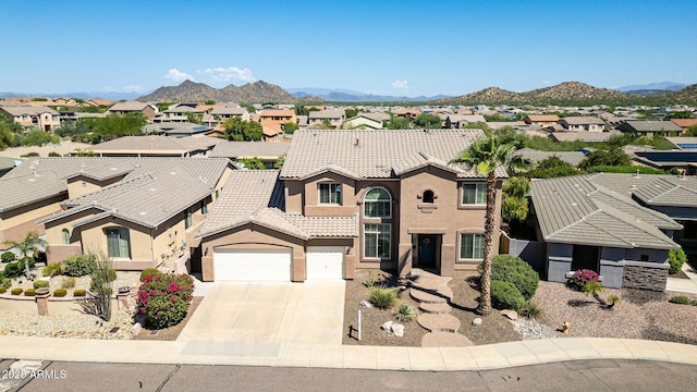 view of front of property featuring a mountain view and a garage