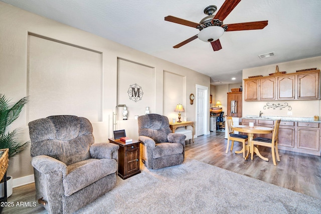 living room with hardwood / wood-style floors and ceiling fan