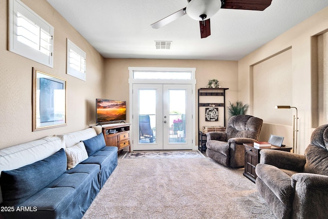 living room featuring ceiling fan, carpet floors, and french doors