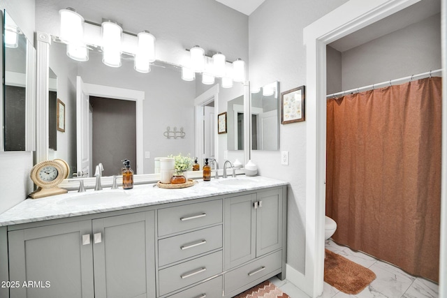 bathroom featuring a shower with shower curtain, vanity, and toilet