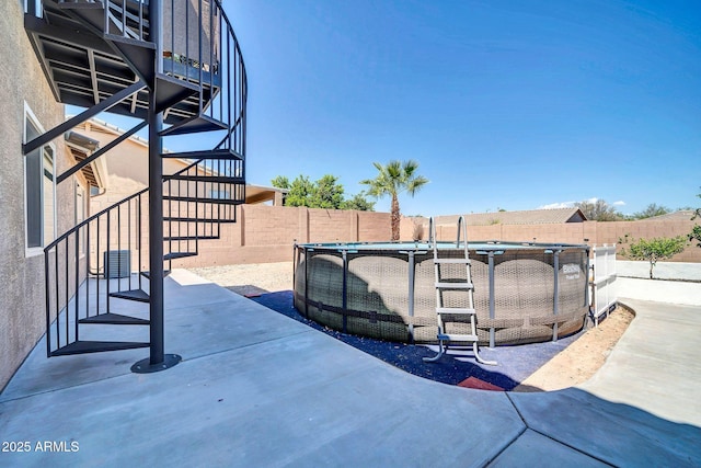 view of patio featuring a fenced in pool