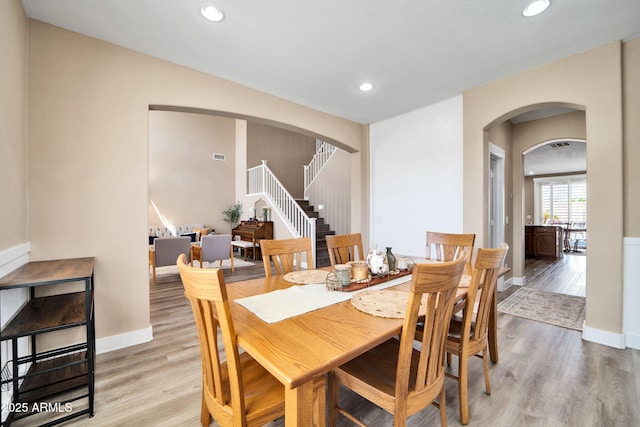 dining space with light hardwood / wood-style floors