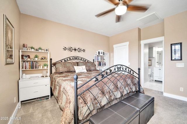 bedroom featuring ceiling fan, carpet floors, and ensuite bathroom