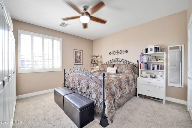 bedroom featuring ceiling fan and light colored carpet