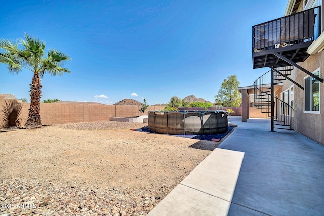 view of yard with a fenced in pool and a patio